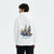 Homme de dos portant un hoodie blanc avec design Red Bull F1 et architecture espagnole, texte “SPAIN” visible